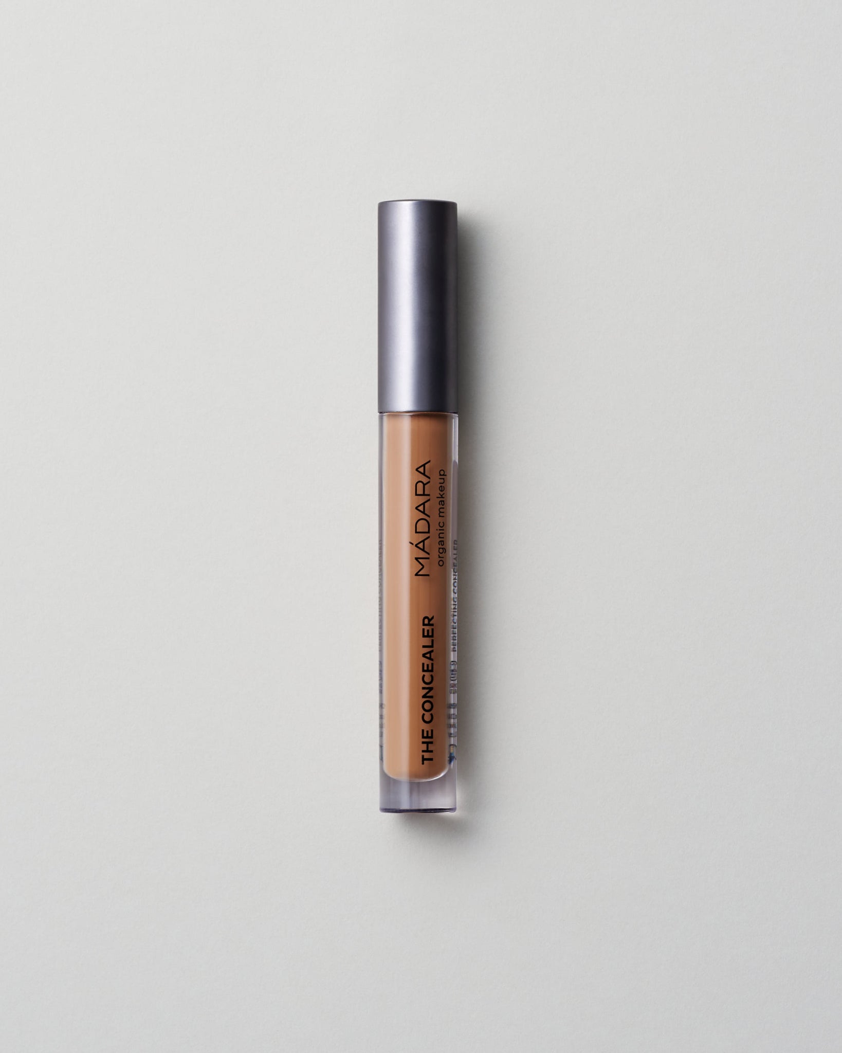 MÁDARA Organic Skincare amber concealer madara cosmetics A6115 concealer product photo on plain background.