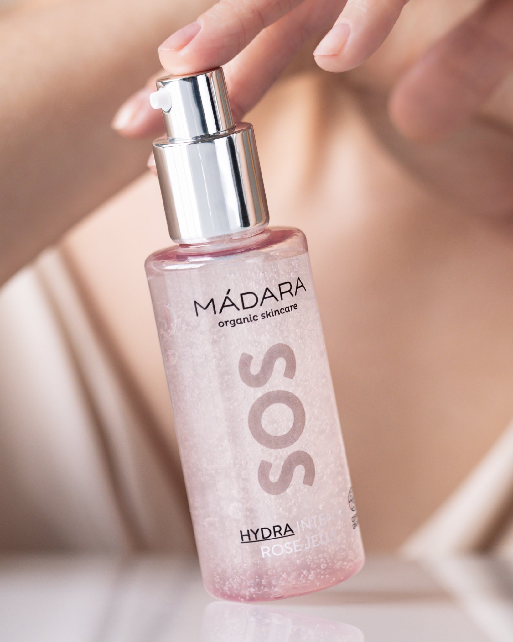 Model wearing MÁDARA Organic Skincare oil free jelly for face A3022 gel moisturizer on skin; close-up portrait shows natural application results.
